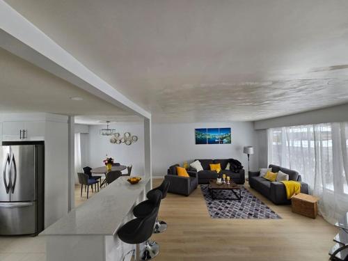 a living room with a couch and a table and chairs at 3 Bedroom Home away from Home in Calgary
