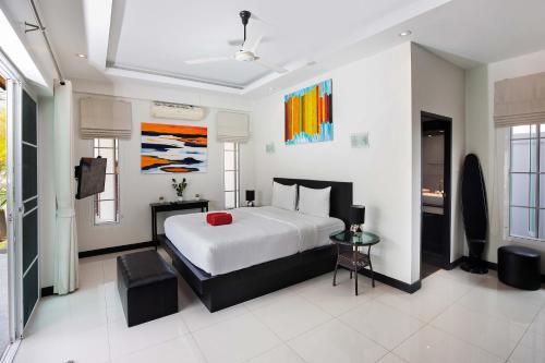 a bedroom with a bed and a television in it at 3BR Villa Marine with Private Pool, Waterfalls in NaiHarn Beach in Rawai Beach
