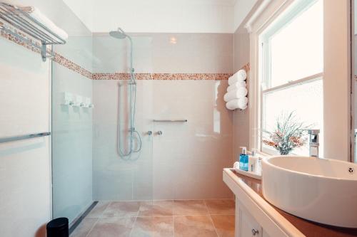 y baño con ducha acristalada y lavamanos. en Rosemont House Luxury BnB en Noojee