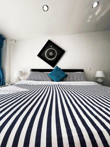 a bedroom with a black and white striped bed at Hotel Puerto Bahia in San Gil