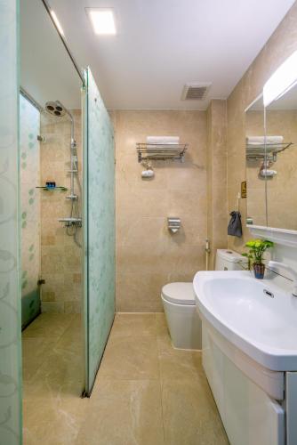 a bathroom with a toilet and a sink and a shower at Bella Premier Hotel & Rooftop Skybar in Hanoi