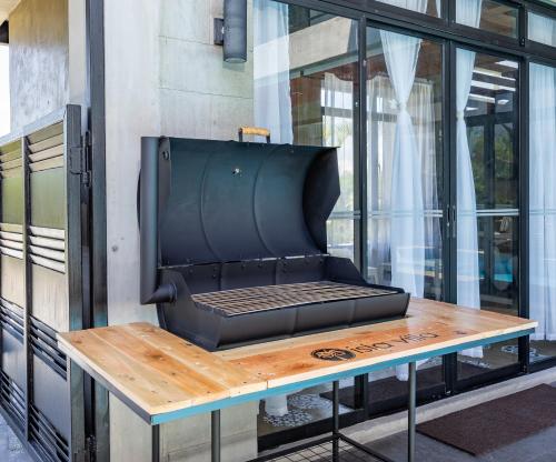 a barbecue grill sitting on a table in front of a building at ISLA VILLA 1 amazing waterfall pool house near beach, bars & restaurants in Mactan