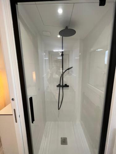 une douche avec une porte vitrée dans une salle de bain dans l'établissement Gîte du Ferrand au coeur des vignes, à Montagne