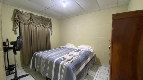a bedroom with a bed with a blue and white blanket at Apartamento dos habitaciones in Mexicanos