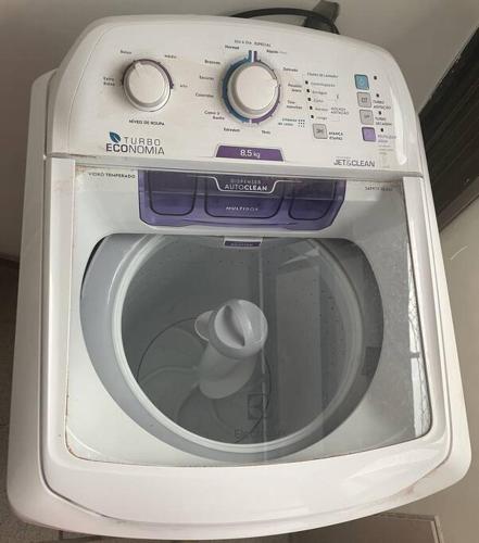 a white washing machine with its door open at Beachfront Condo Large Apartament in Rio de Janeiro