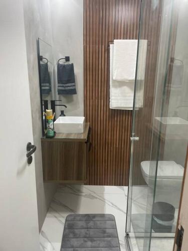 a bathroom with a shower and a sink and a toilet at Beachfront Condo Large Apartament in Rio de Janeiro