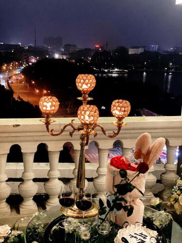 a balcony with a glass table with angels on it at Asean Hotel in Hải Dương