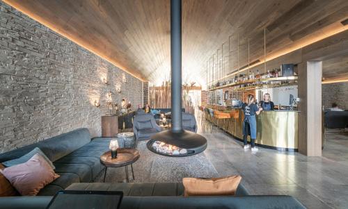 a living room with a couch and a fireplace at Kamana Lakehouse in Queenstown