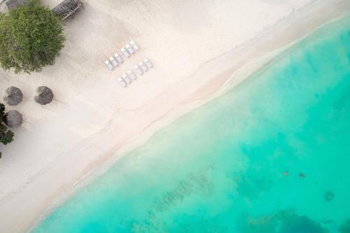an overhead view of a beach with chairs and the water at Courtyard by Marriott Aruba Resort in Palm-Eagle Beach