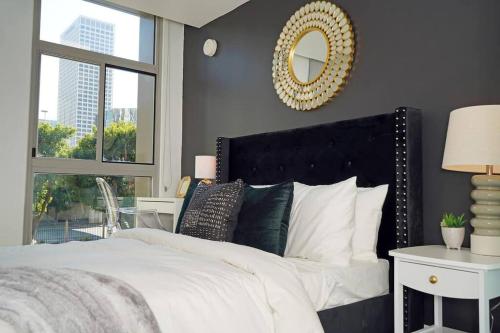 a bedroom with a large bed with a mirror on the wall at Downtown LA- Free Parking - Style in the City in Los Angeles