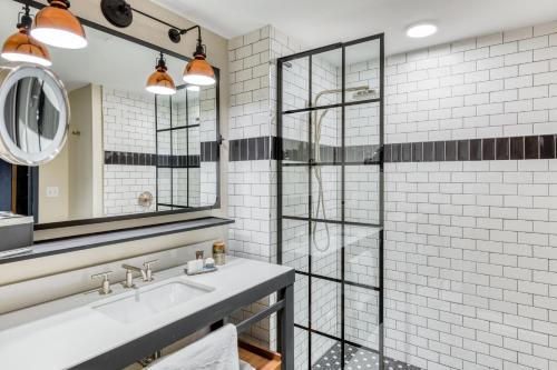 a bathroom with a sink and a shower at The Sessions Hotel, Bristol, a Tribute Portfolio Hotel in Bristol