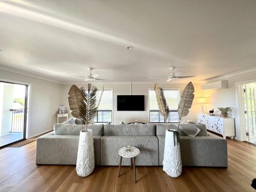 a living room with a couch and a tv at Forever Endeavour in Mission Beach