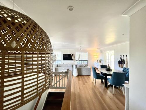 a living room and dining room with a table and chairs at Forever Endeavour in Mission Beach