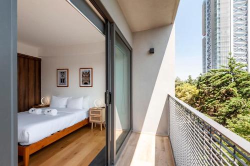 a bedroom with a bed and a balcony at Amazing 2BR in Condesa in Mexico City