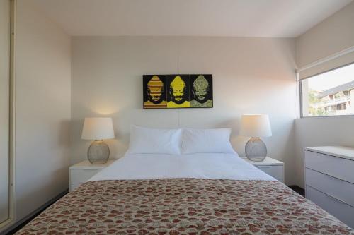 a bedroom with a large bed and two lamps at The Gem-Executive Potts Point Harbourview Stunner in Sydney