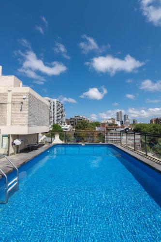 a large swimming pool on top of a building at The Gem-Executive Potts Point Harbourview Stunner in Sydney