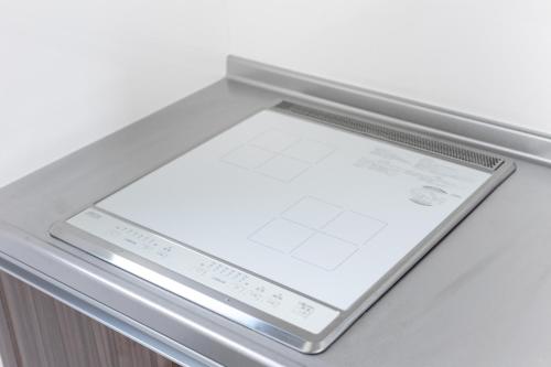 an open refrigerator door with a tablet on the shelf at 67 Apt Koenji Tokyo in Tokyo