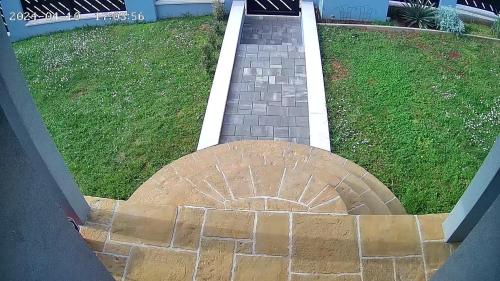 a brick walkway leading to a driveway at Holiday Home Mihaela in Višnjan