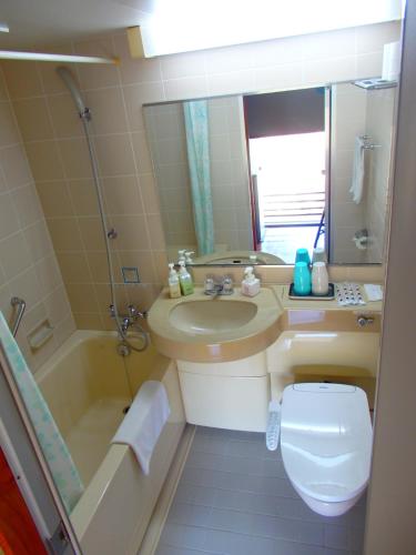 a bathroom with a sink and a toilet and a tub at Forest Villa YUMESUZU the Closest Accommodation to the Metasequoia Tree-lined Avenue in Takashima