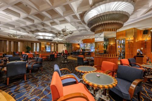 a lobby of a hotel with chairs and tables at Centara Grand at Central Plaza Ladprao Bangkok in Bangkok
