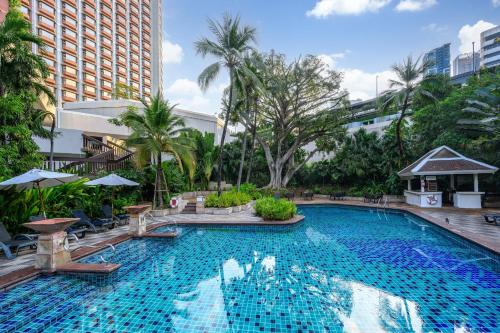 a large swimming pool in the middle of a city at Centara Grand at Central Plaza Ladprao Bangkok in Bangkok