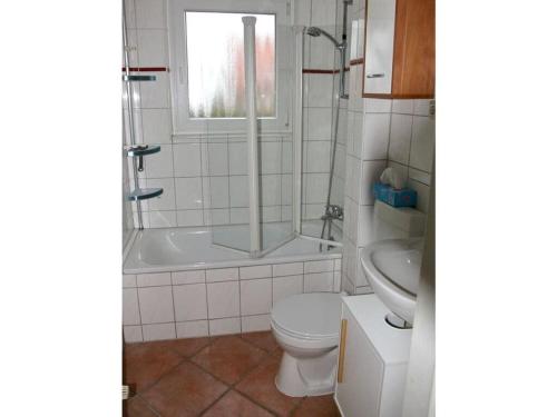 y baño con ducha, aseo y lavamanos. en Snug holiday home with garden, en Timmendorfer Strand