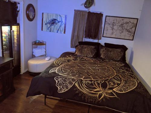 a bedroom with a bed with a gold and black bedspread at Bunny's Bungalow in Las Vegas