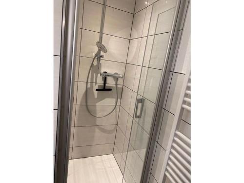 een douche met een slang in de badkamer bij Wingertsblick Modern retreat in Graach