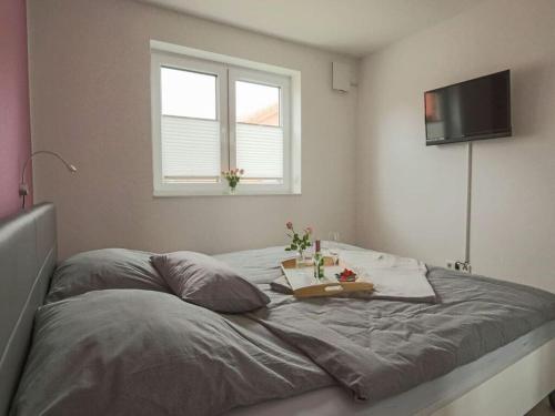 a bed with a tray of flowers on top of it at Marinapark 147 Modern retreat in Walchum