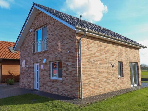 a red brick house with a solar roof at Marinapark 147 Modern retreat in Walchum