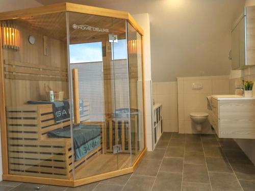 a bathroom with a glass shower in a room at Marinapark 147 Modern retreat in Walchum