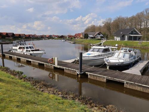 three boats are docked at a dock in the water at Marinapark 147 Modern retreat in Walchum