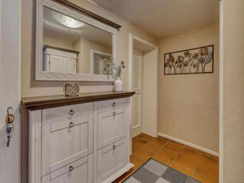 a bathroom with a white dresser and a mirror at Waldhaus Sonnenberg Apartment 1 in Drachselsried