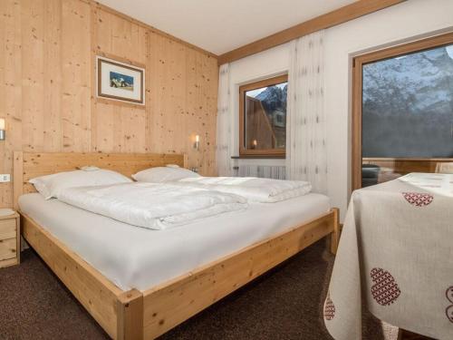 Un dormitorio con una cama grande y una ventana en Spacious holiday home with balcony en Carezza al Lago
