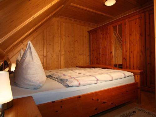 a small bed in a wooden room with at Am Turm Modern retreat in Mellrichstadt