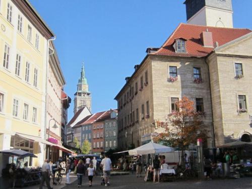 a group of people walking around a street with buildings at Rose ambience Modern retreat in Bad Langensalza