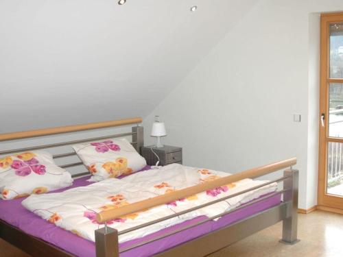 a bedroom with a bed with flowers on it at Holiday home Altmühltal in Beilngries
