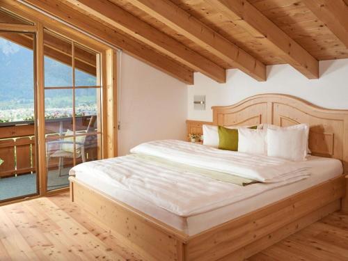 a bedroom with a large bed with a large window at Oberstdorf dream view - Alpine star in Oberstdorf