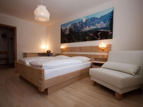 a bedroom with a large bed and a couch at Columbine Modern Retreat in Carezza al Lago
