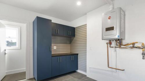 a kitchen with blue cabinets and a microwave at Happy party house in Los Angeles