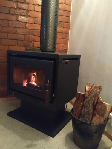 a black stove with a fire in a pot at Close to Town and Very Private in Myrtleford