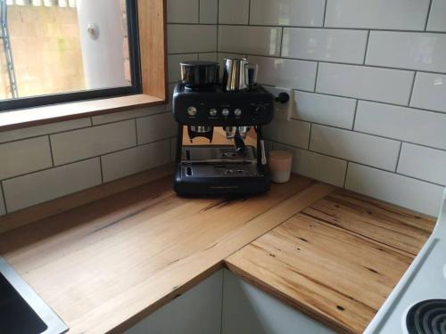 a coffee maker sitting on a wooden counter in a kitchen at Close to Town and Very Private in Myrtleford