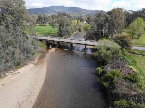 an aerial view of a bridge over a river at Close to Town and Very Private in Myrtleford