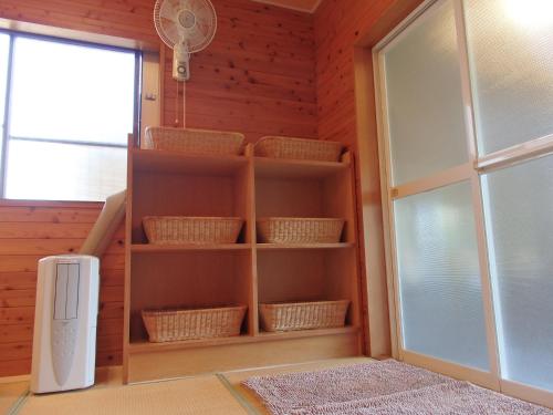 a room with a book shelf and a window at Forest Villa YUMESUZU the Closest Accommodation to the Metasequoia Tree-lined Avenue in Takashima