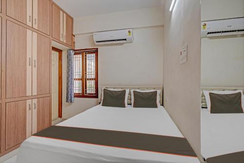a small room with two beds in it at Collection O Ns Service Apartment in Tirupati
