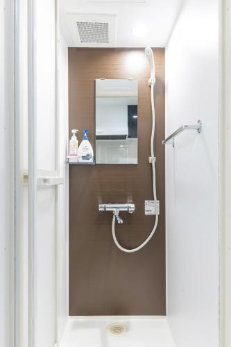 a bathroom with a shower with a mirror at 67 Apt Koenji Tokyo in Tokyo