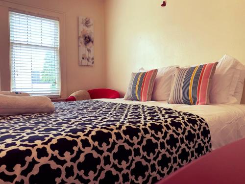 a bedroom with a bed with a black and white comforter at Seattle Urban Village- OL in Seattle