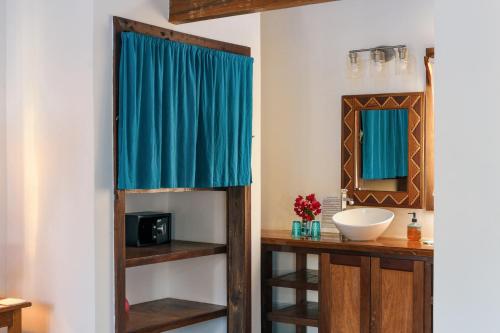 a bathroom with a sink and a mirror at North Beach Retreat in San Pedro