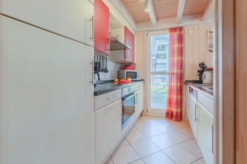 a kitchen with white appliances and a window at Ferienhaus Seepferdchen in Baabe