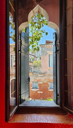 an open window with a view of a building at Messner Palace in Venice
